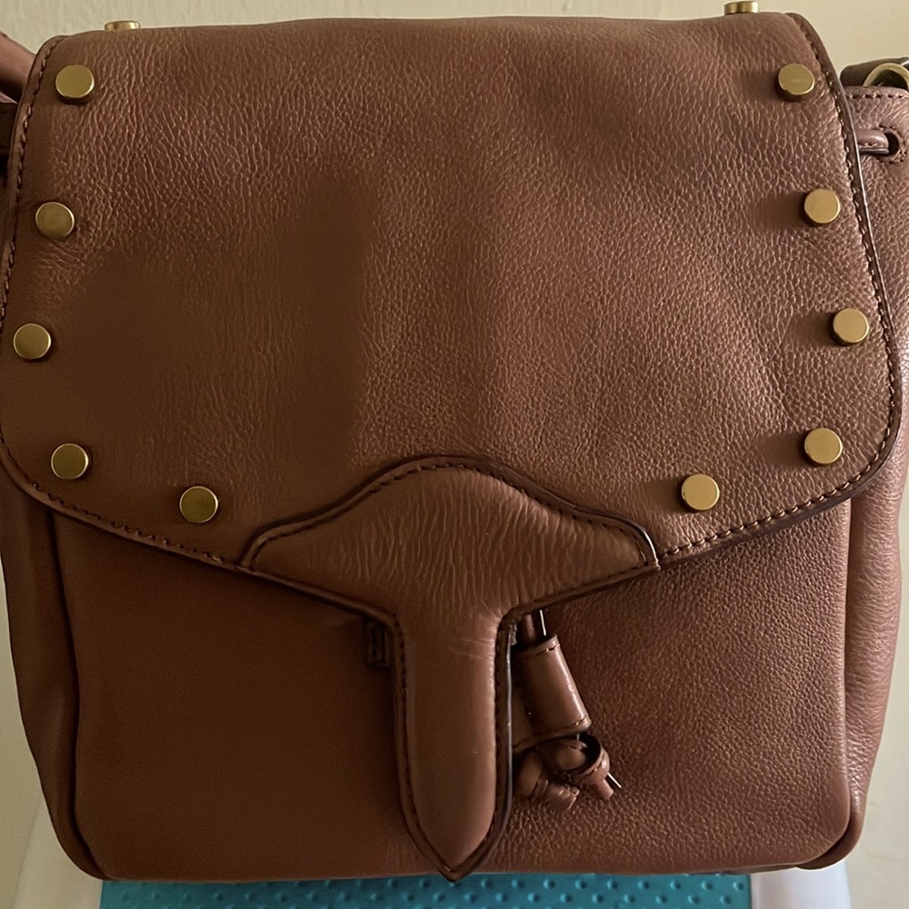 Bag lucky brand crossbody with a slide in snap closure.gold color studs.NWT